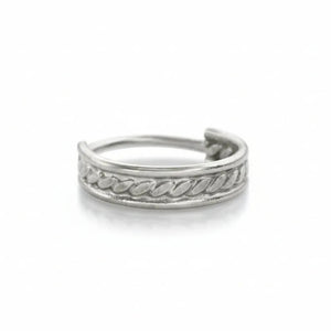 A silver ring with a decorative band design.