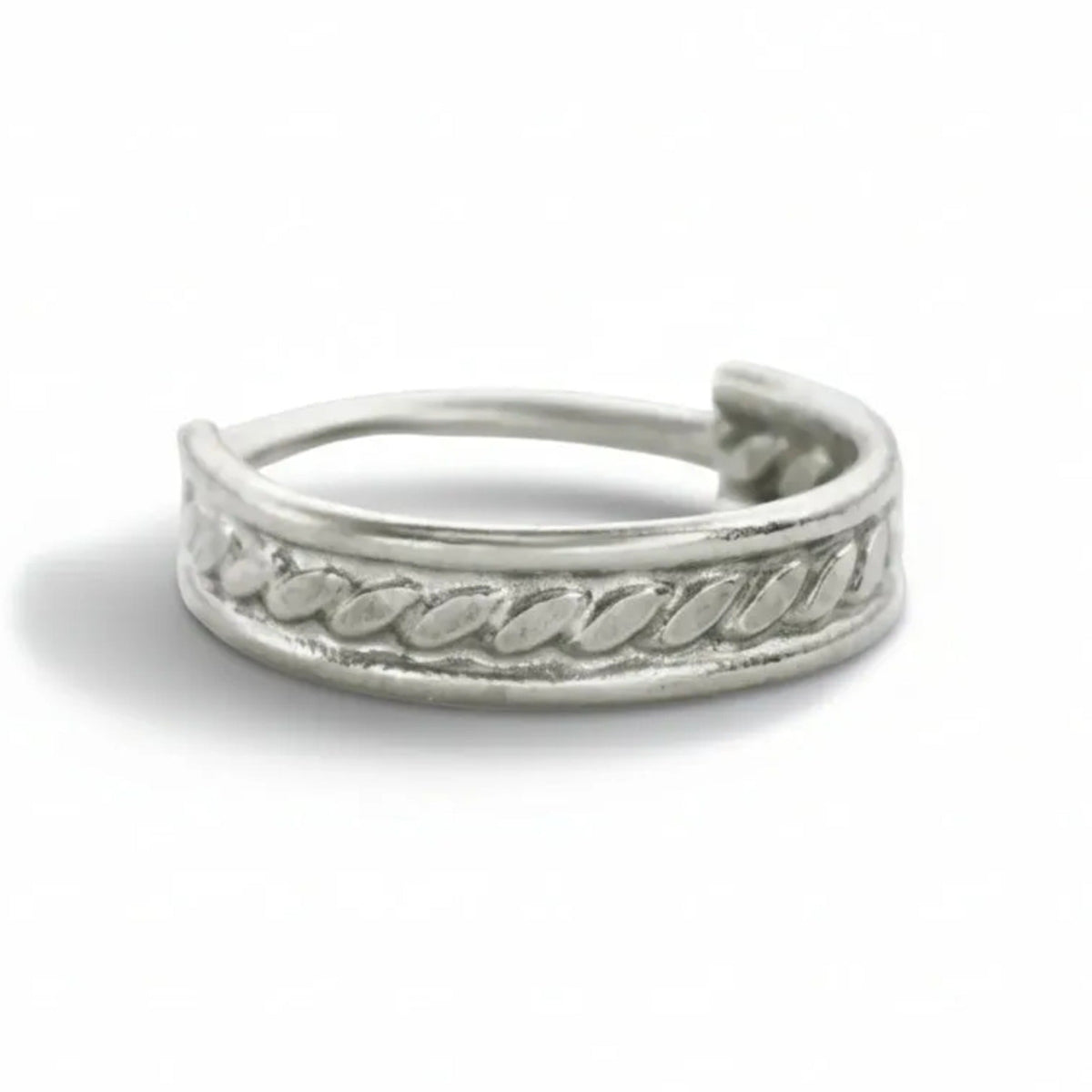 A silver ring with a decorative band design.