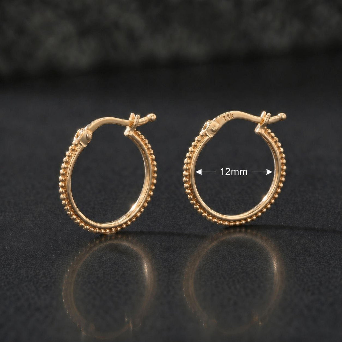 two gold earrings with a detailed view of their design, including the size and dimensions.