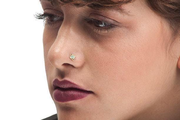 A close-up of a woman's face, focusing on her nose and lips.