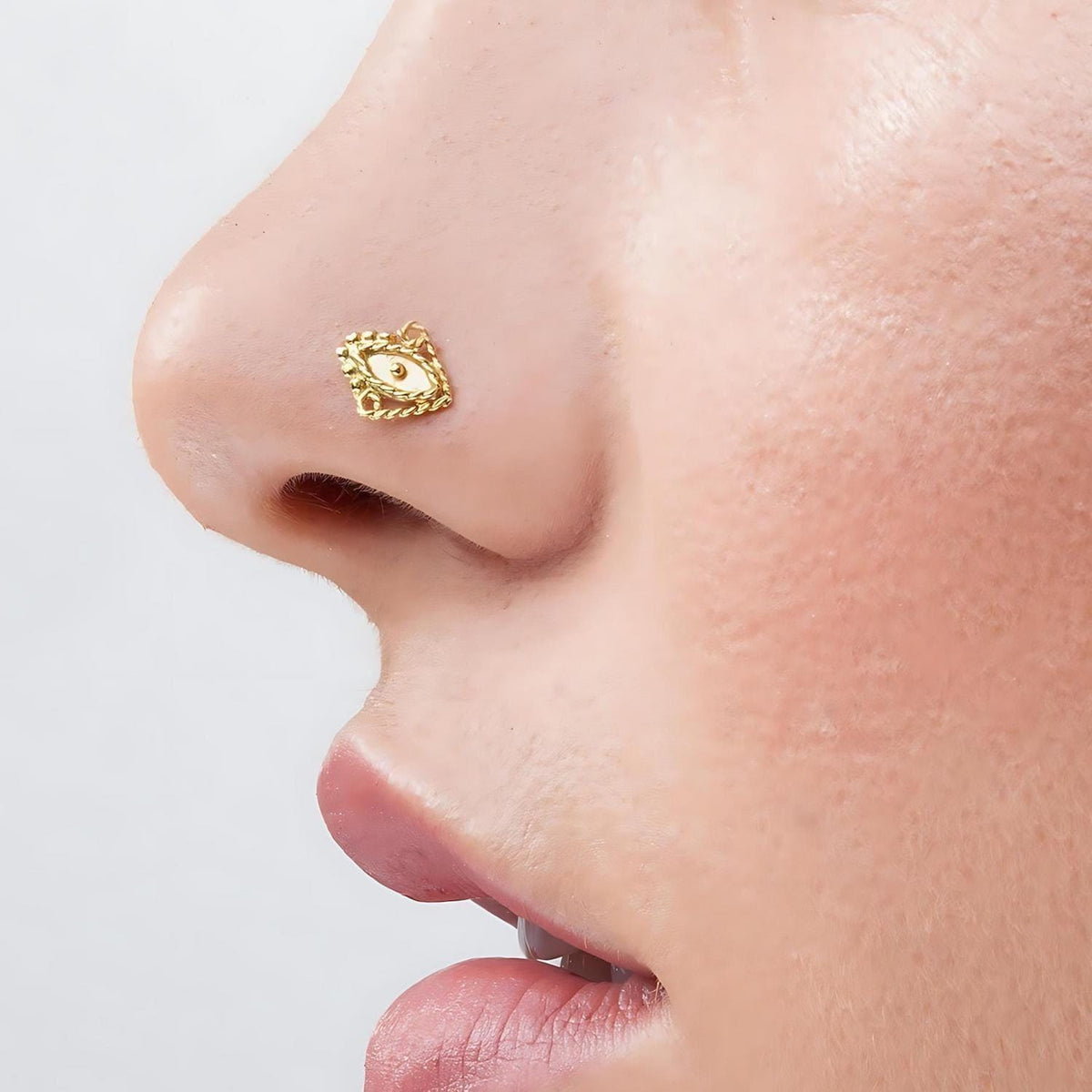 Indian Solid Gold Nose Stud: A close-up of a person's face, focusing on their nose and mouth area.