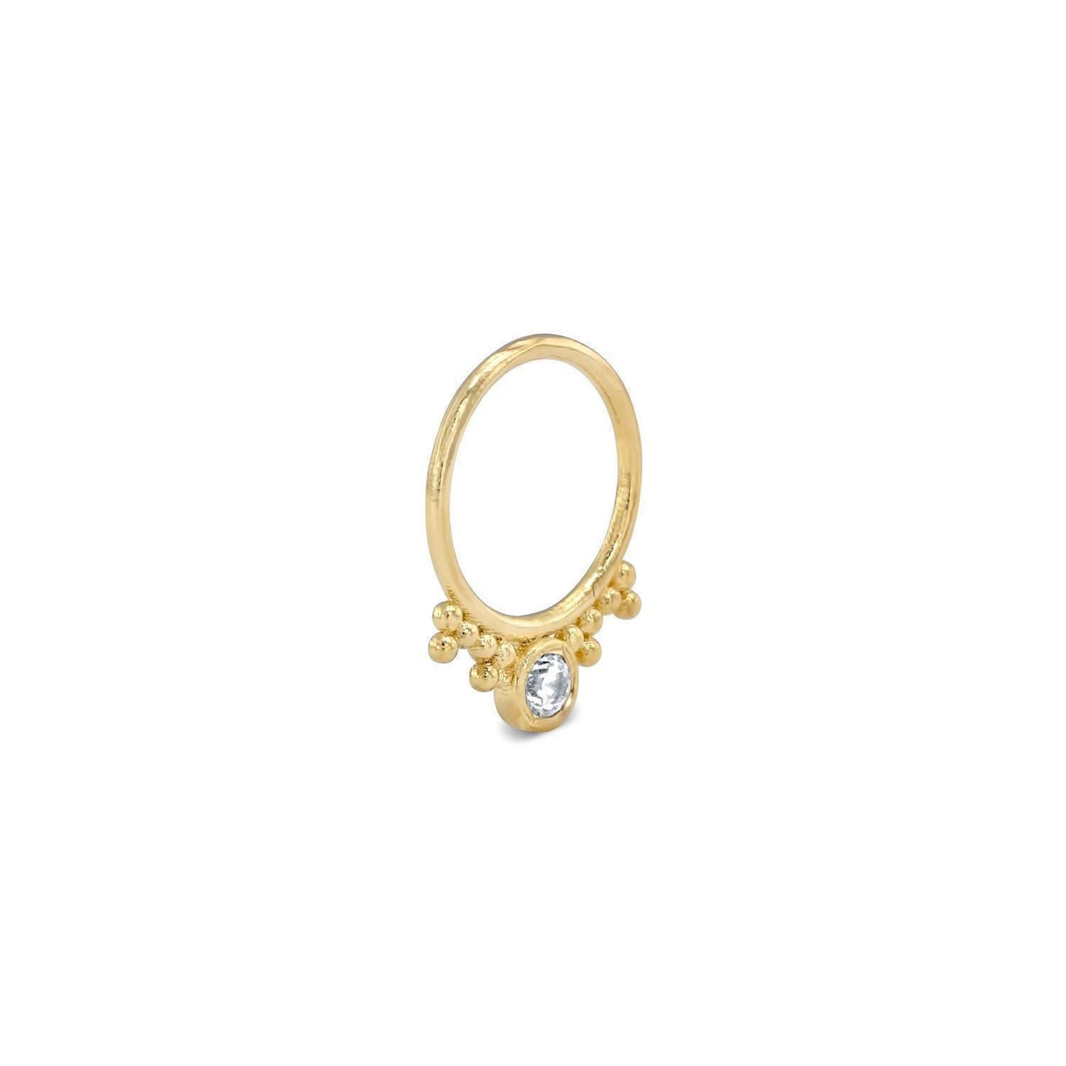 A gold ring with a clear gemstone, possibly a diamond, set in the center.