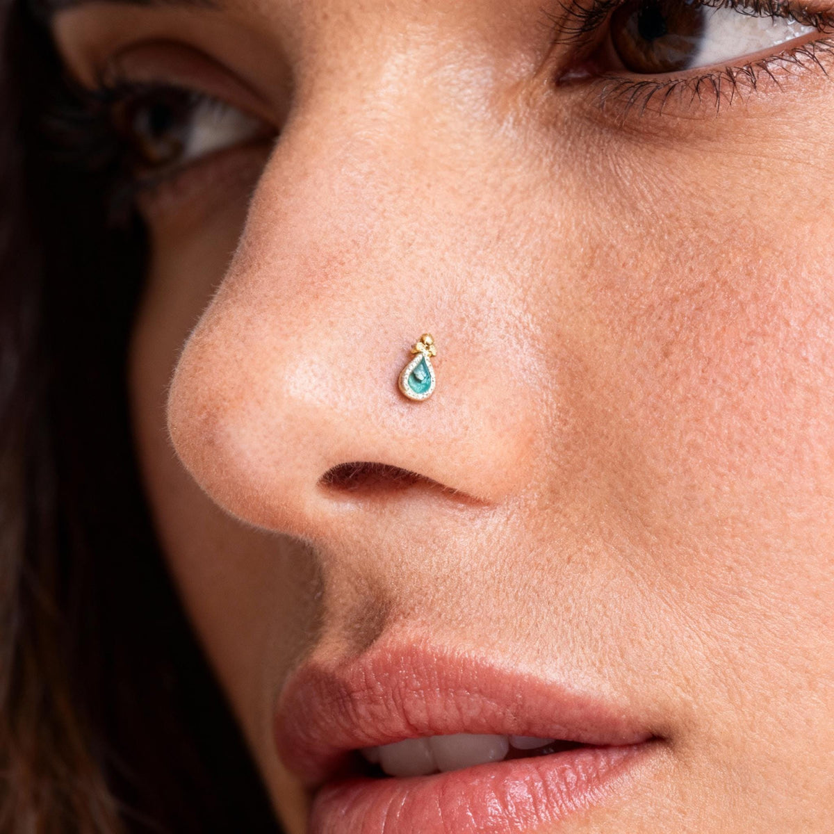 A close-up of a woman's face, focusing on her nose and lips.
