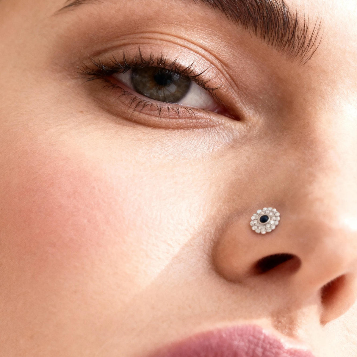 A close-up of a woman's face, focusing on her eyes, nose, and lips.