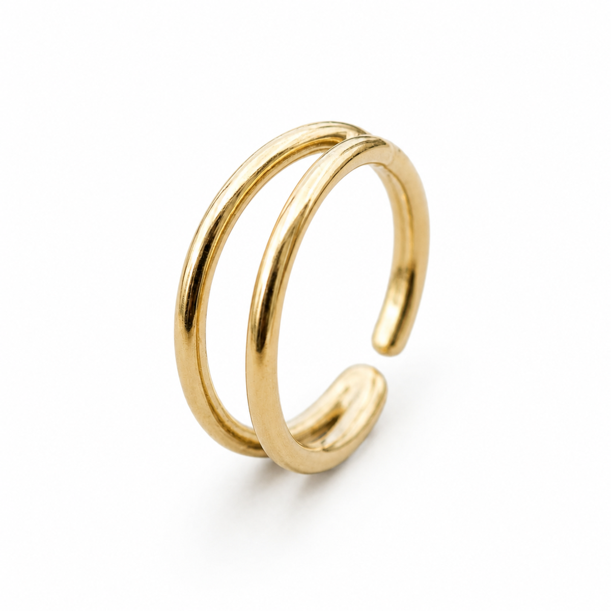 A gold-colored ring with two overlapping bands, set against a white background.