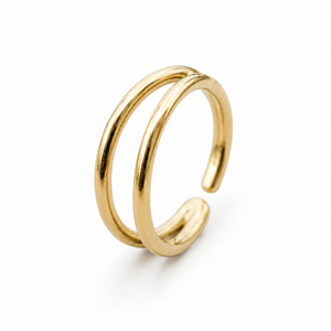 A gold-colored ring with two overlapping bands, set against a white background.