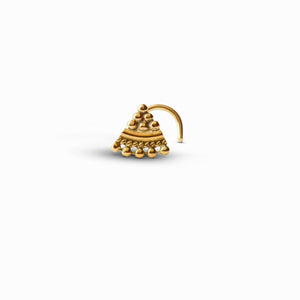 A gold-colored nose stud with a decorative design.