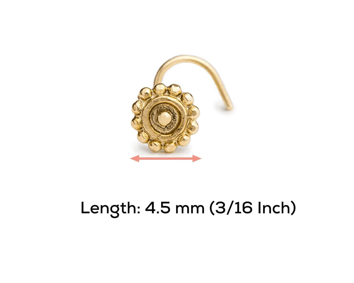 A gold-colored nose ring with a decorative design, accompanied by a measurement indicating its length.