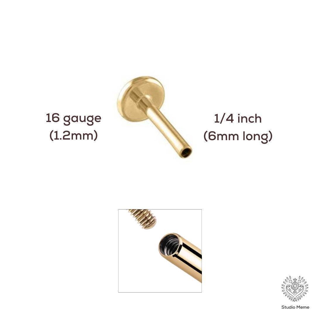a gold-colored metal piece, possibly a piercing or jewelry component, with measurements and a close-up view of the piece.
