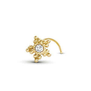 A gold-colored nose ring with a diamond-like center stone surrounded by small, round beads or stones.