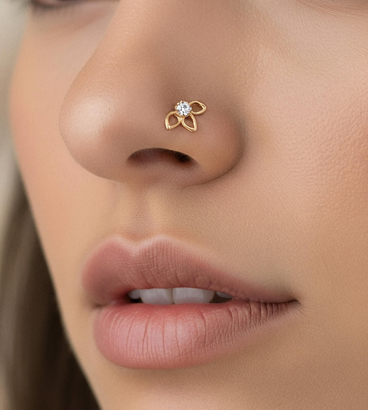 Lotus Nose Stud: A close-up of a person's face, focusing on their nose and lips.