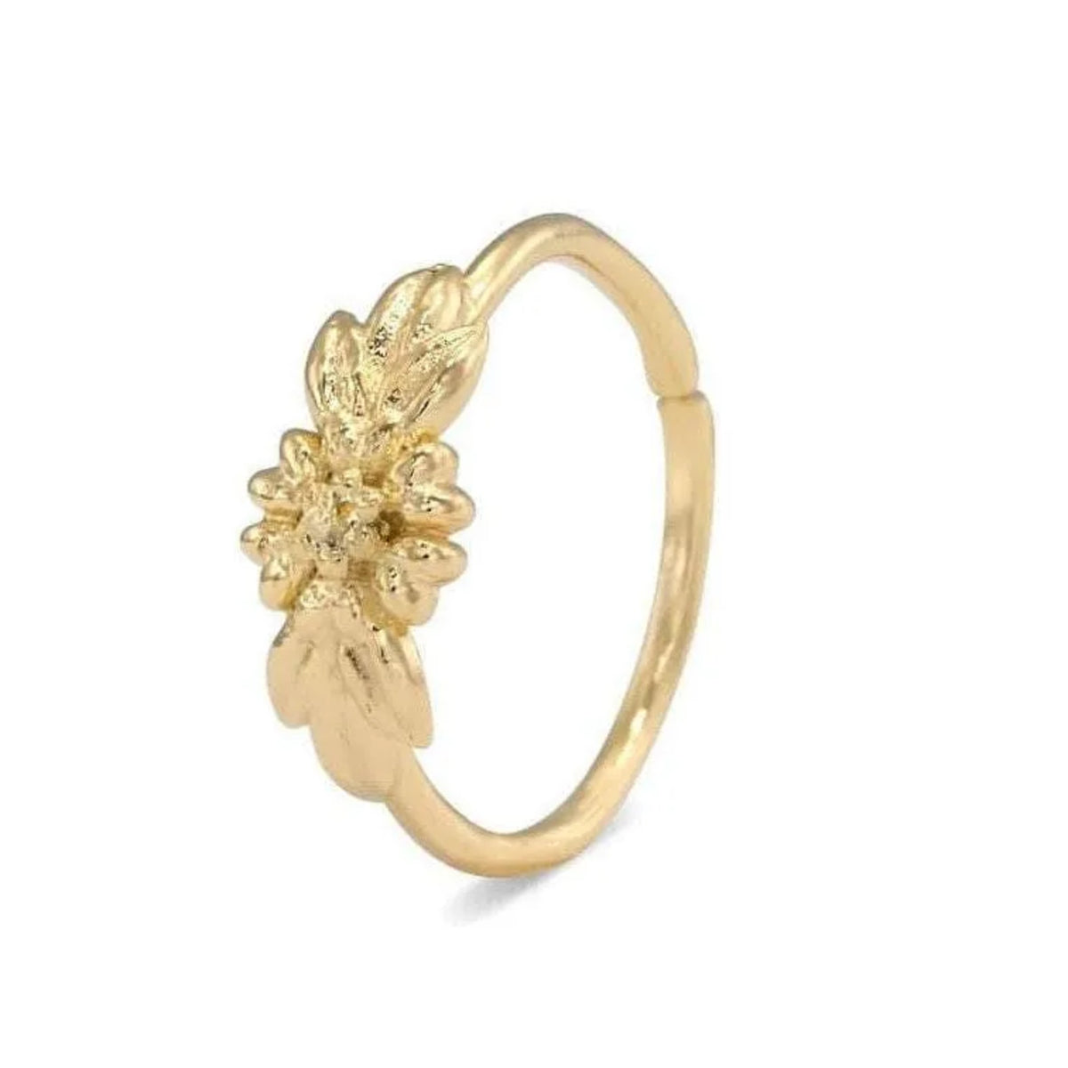 A gold-colored ring with a floral design on the side.