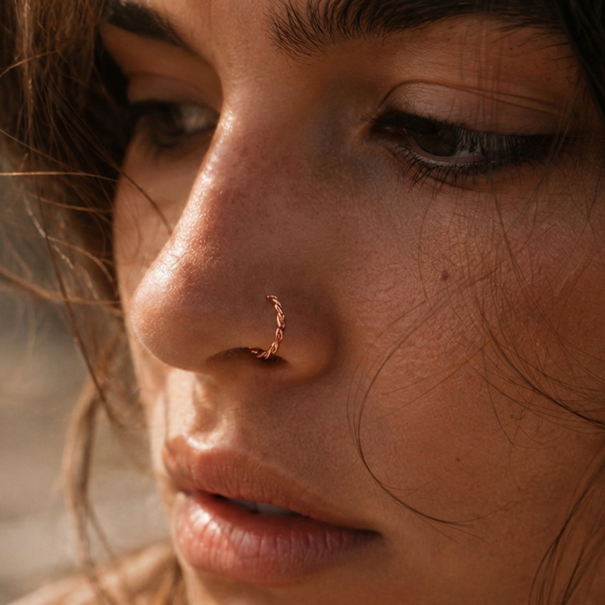 A close-up of a woman's face, focusing on her nose and the surrounding skin.