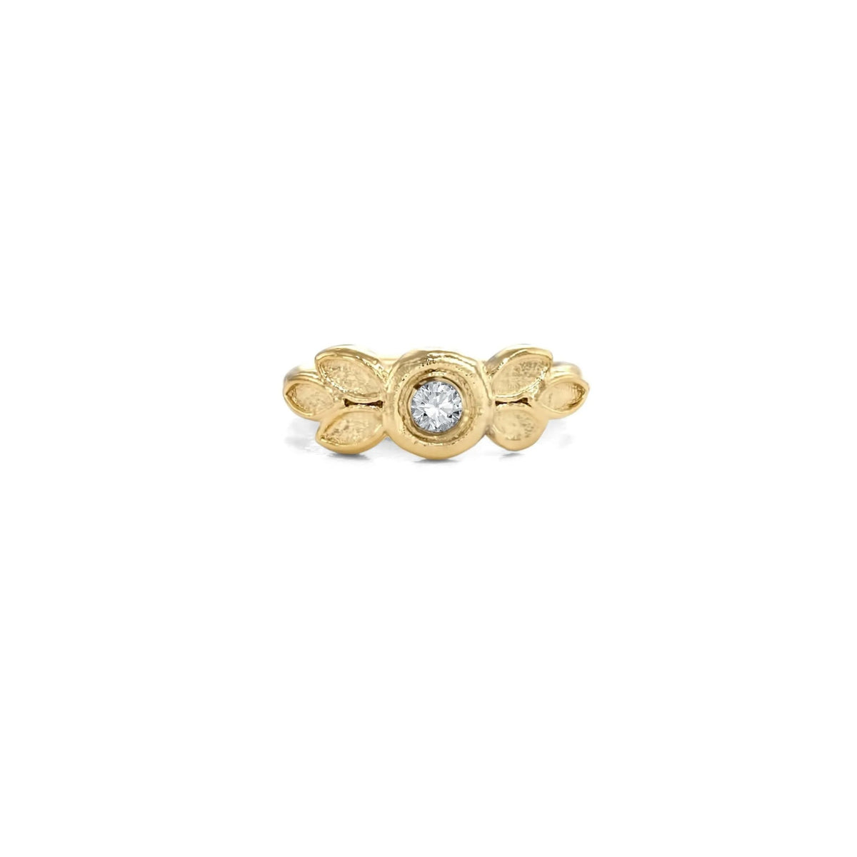 A gold ring with a diamond in the center, surrounded by leaf-shaped designs.