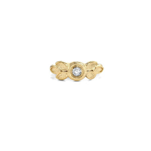 A gold ring with a diamond in the center, surrounded by leaf-shaped designs.