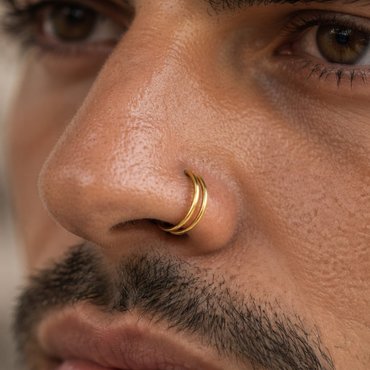 A close-up of a man's face, focusing on his nose and facial features.