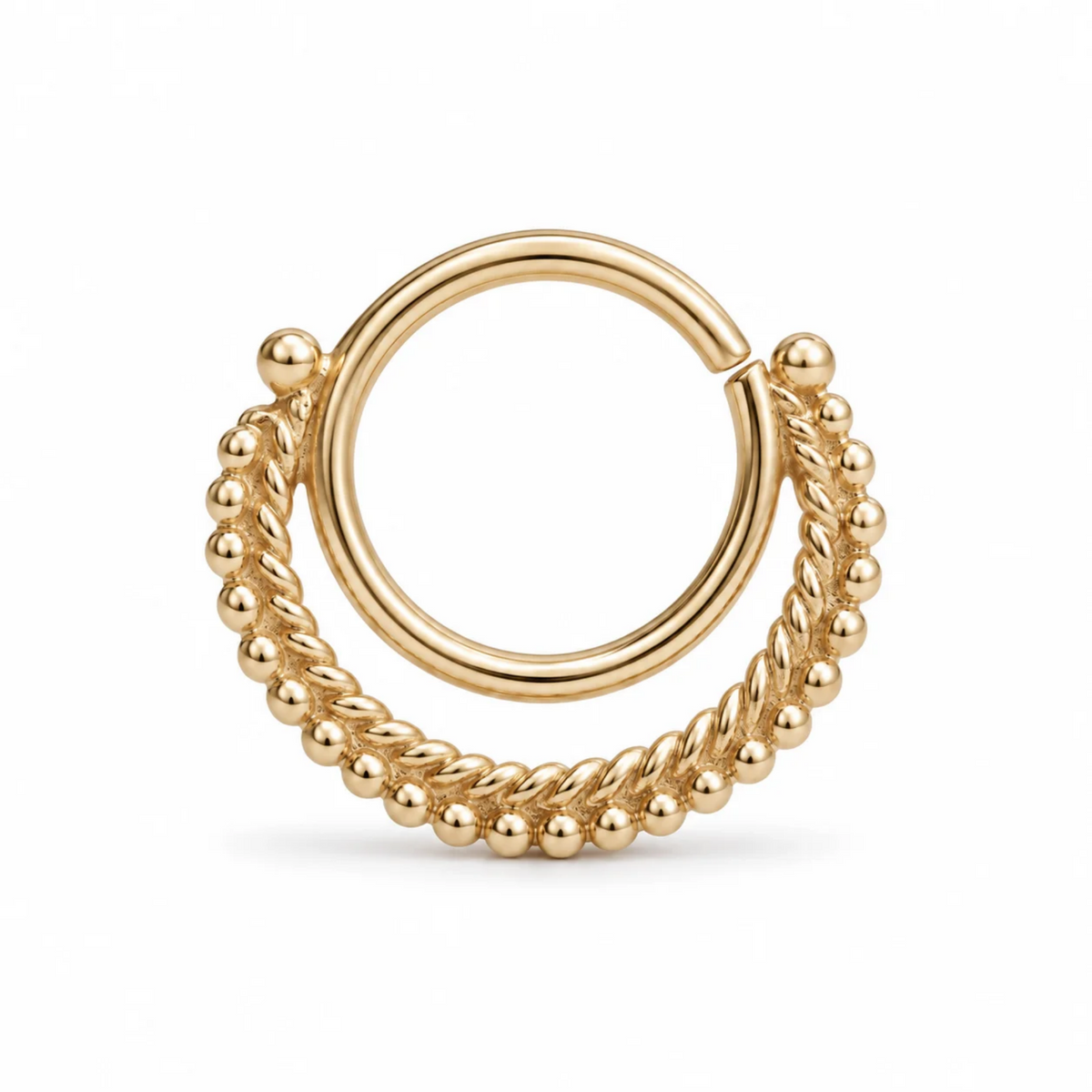 A gold-colored metal ring with a twisted design and small, round beads or stones attached to it.