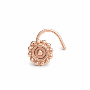 A copper-colored nose ring with a decorative floral design.
