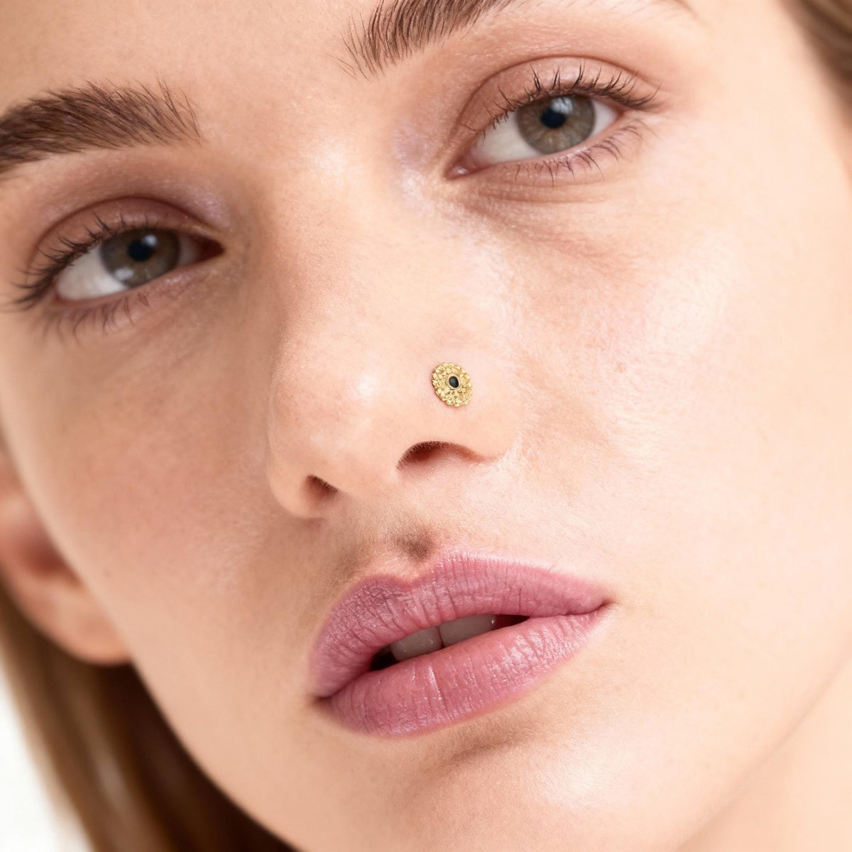 A close-up of a woman's face, focusing on her nose and lips.