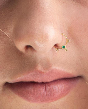 Solid Gold Nose Ring: A close-up of a person's face, focusing on their nose and lips.