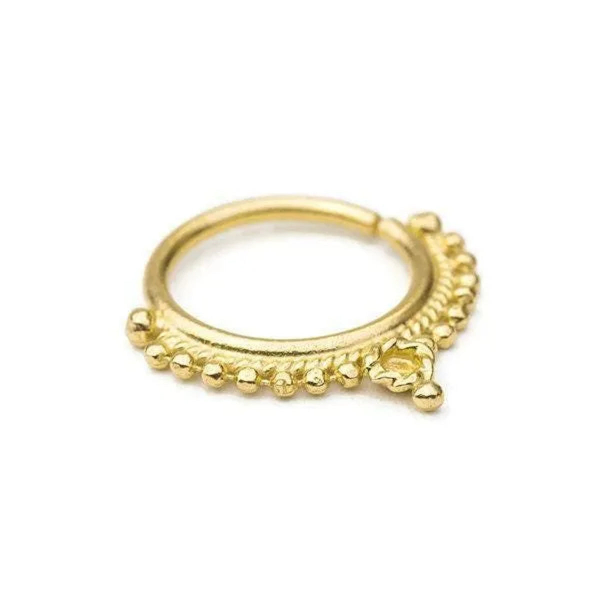 A gold-colored metal ring with a decorative element on the side.