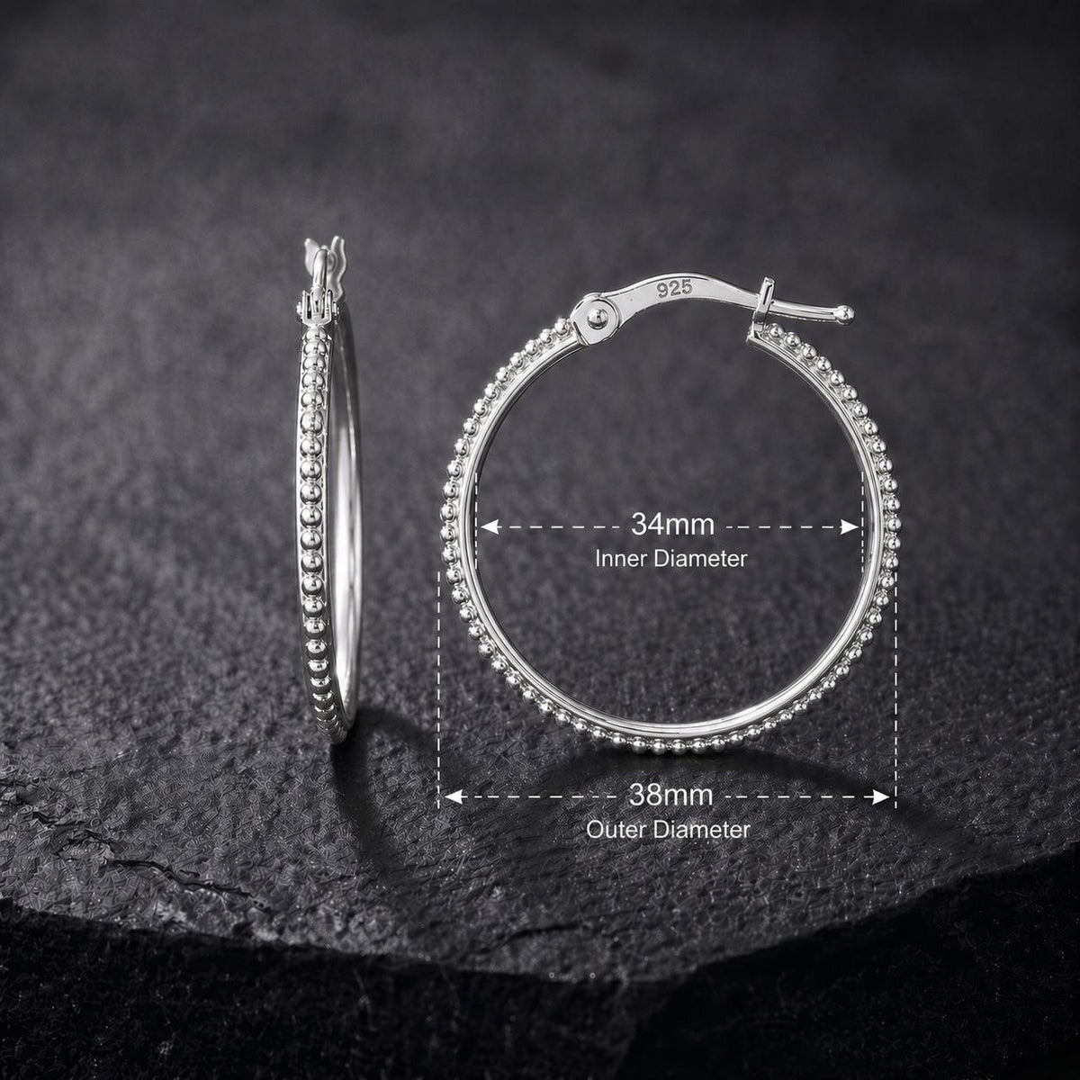 A close-up image of a pair of silver hoop earrings with a detailed measurement scale indicating the inner and outer diameter.