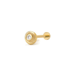 Tragus Piercing Earring: A gold-colored earring with a small diamond in the center.