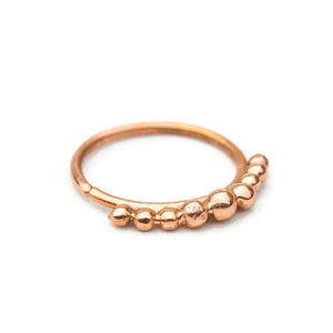 A copper-colored ring with a row of small, round beads or stones along the edge.