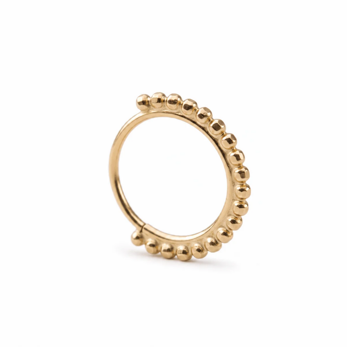 A gold-colored ring with a row of small, round beads or stones along the edge.