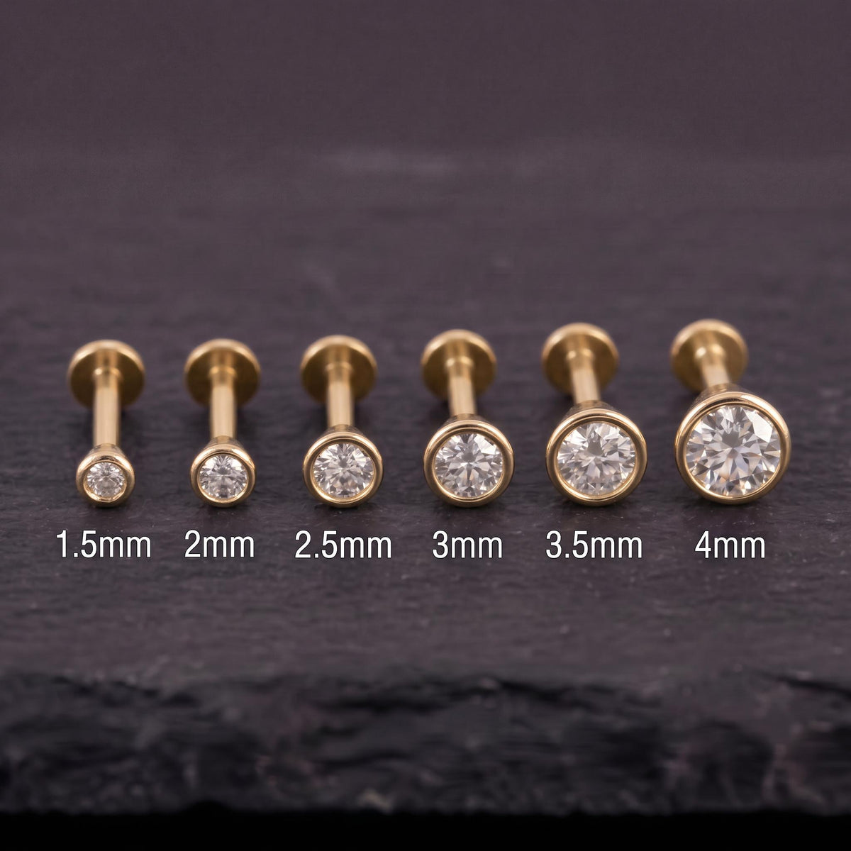 A collection of six gold-colored diamond-encrusted piercings, each with a different size ranging from 1.5mm to 4mm.