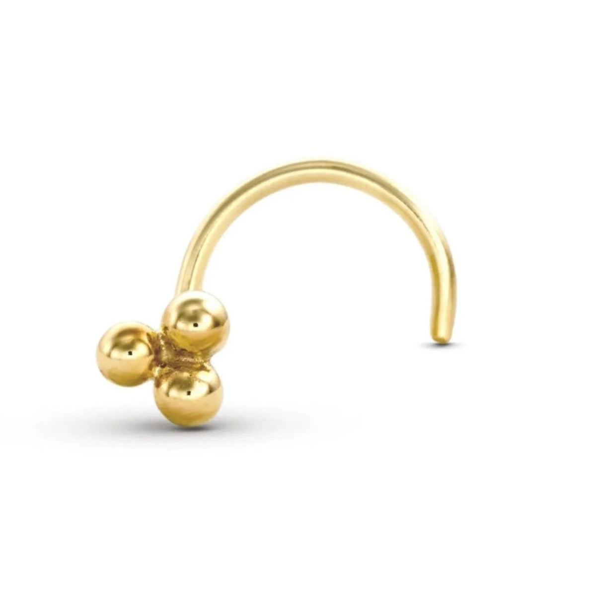 A gold-colored metal nose ring with three small balls on it.