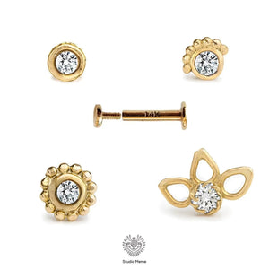 Tragus Stud Earring: five gold-colored earrings with diamonds, including stud earrings, drop earrings, and a floral-shaped earring.