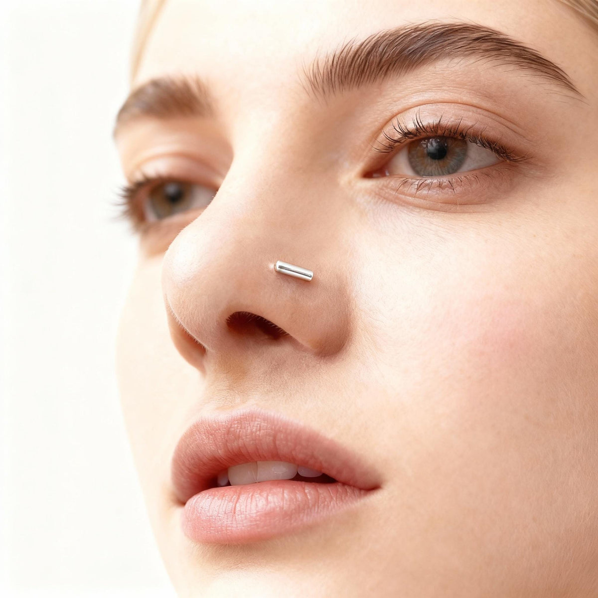 A close-up of a woman's face, focusing on her nose and lips.