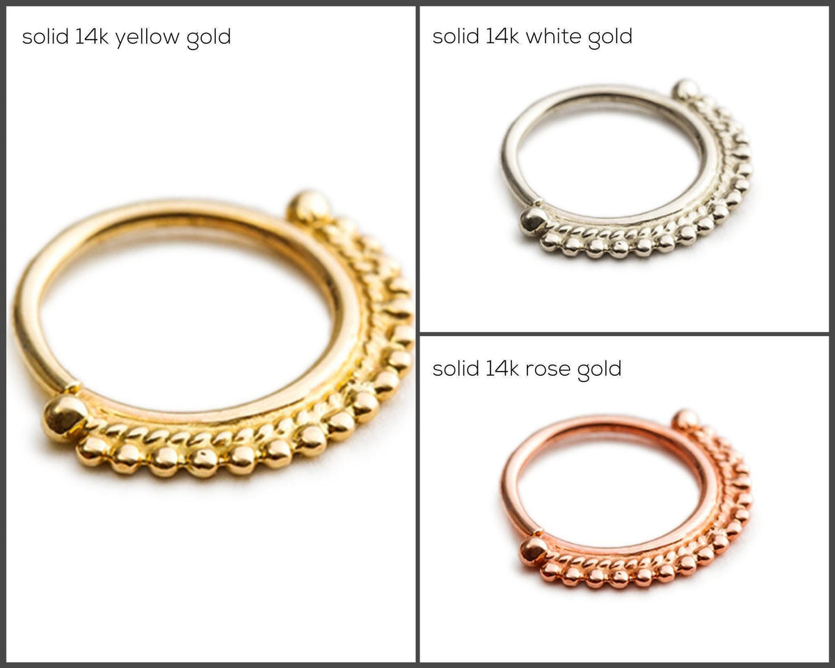 three different types of nose rings, each with a distinct color and material. The first ring is solid 14k yellow gold, the second is solid 14k white gold, and the third is solid 14k rose gold.