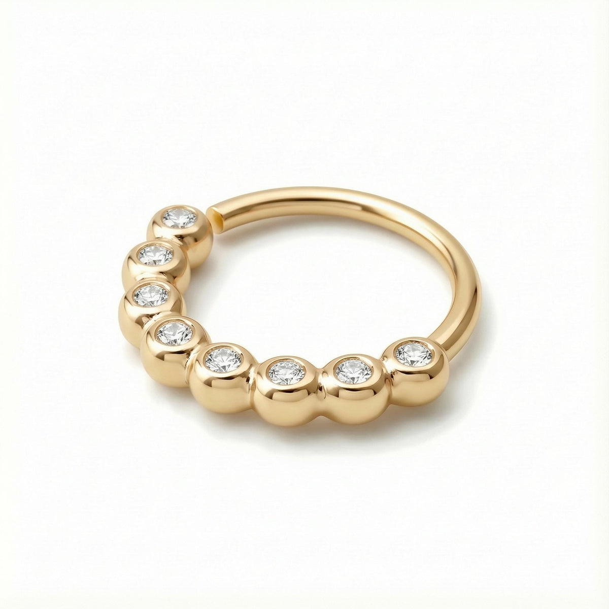 Diamond Nose Hoop: a yellow gold ring with a row of small diamonds set in it.