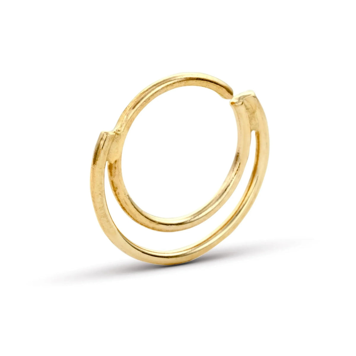 A gold-colored ring with a unique, twisted design.