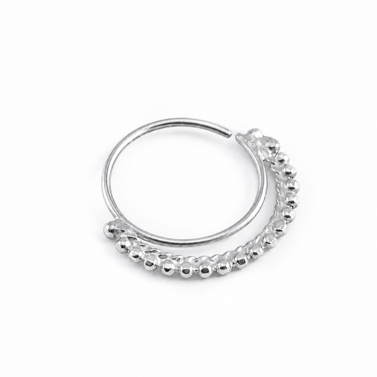 A silver-colored metal ring with a curved design and a row of small, round beads or stones attached to it.