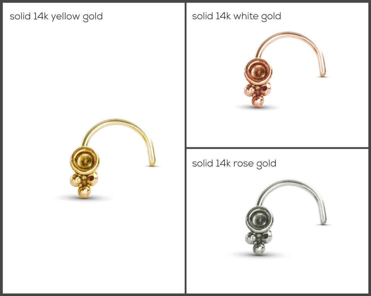 four different types of nose piercings, each with a unique color and material. The piercings are solid 14k yellow gold, solid 14k white gold, solid 14k rose gold, and solid 14k silver.