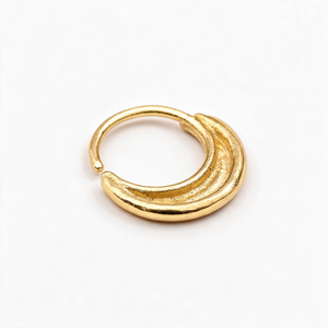 A gold-colored hoop earring is shown against a white background.