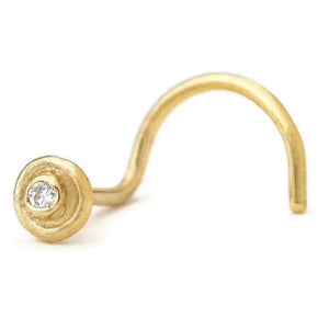 A gold-colored nose ring with a small diamond in the center.