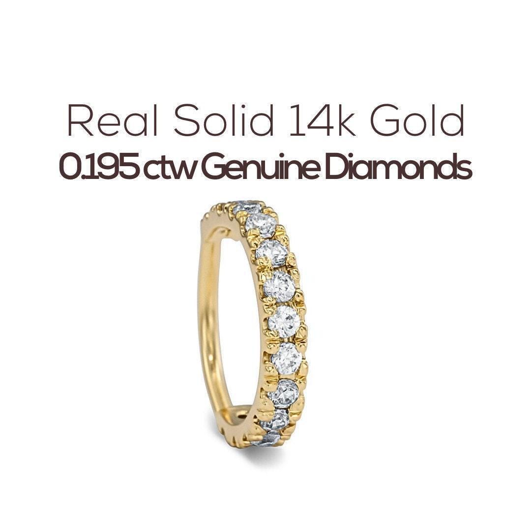 a gold ring with a row of genuine diamonds set in it.