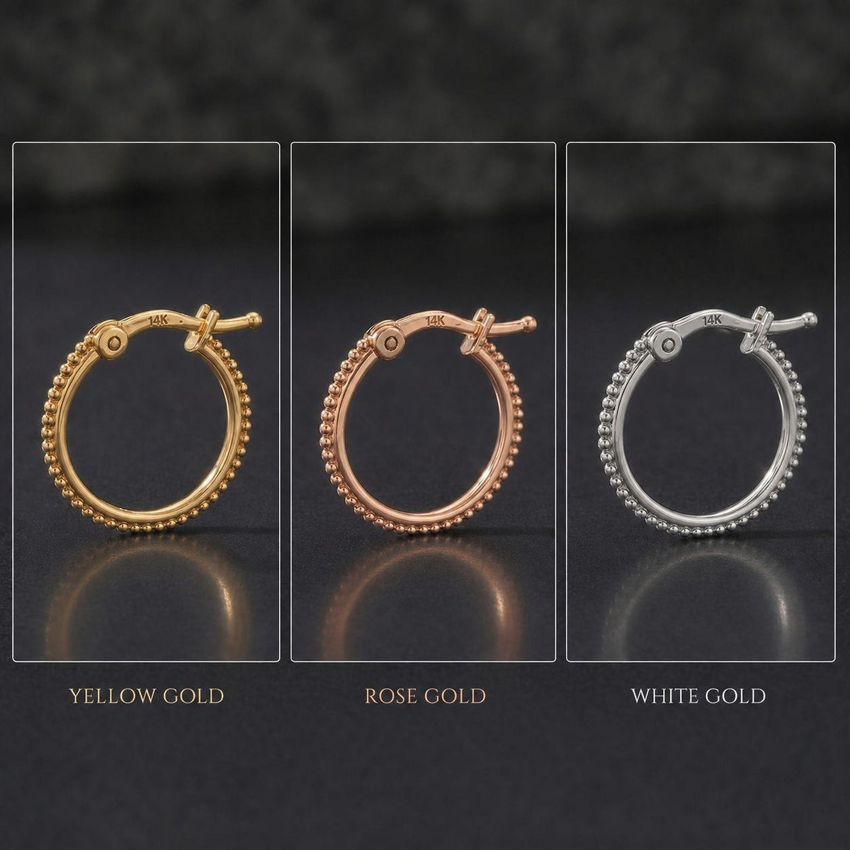 three different colored gold earrings, each with a unique design and size, arranged in a row against a dark background.