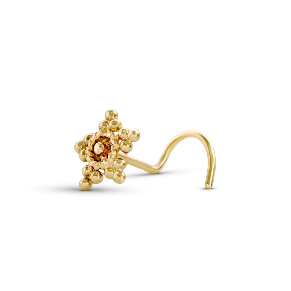 A gold-colored nose ring with a floral design and small spherical elements.