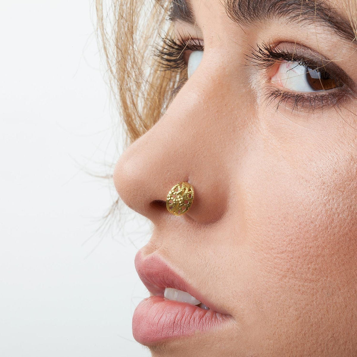 A close-up of a woman's face, focusing on her nose and lips.