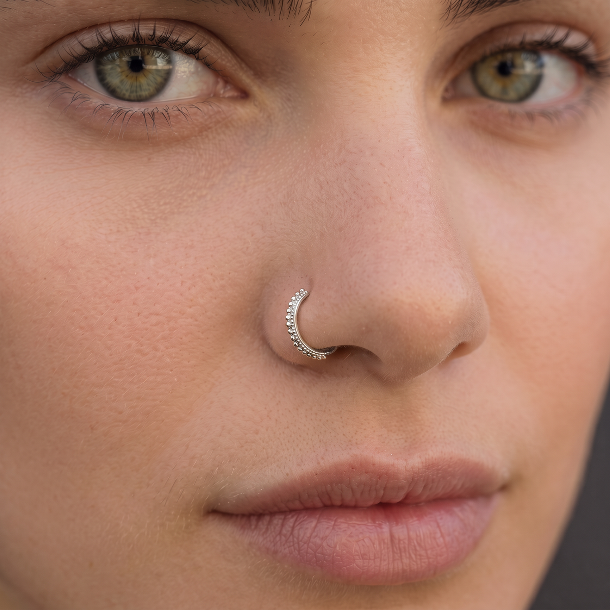 A close-up of a woman's face, focusing on her nose and lips.