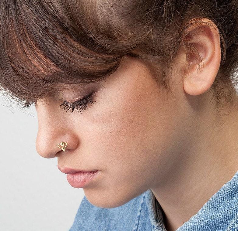 A close-up of a person's face, focusing on their nose and chin area.
