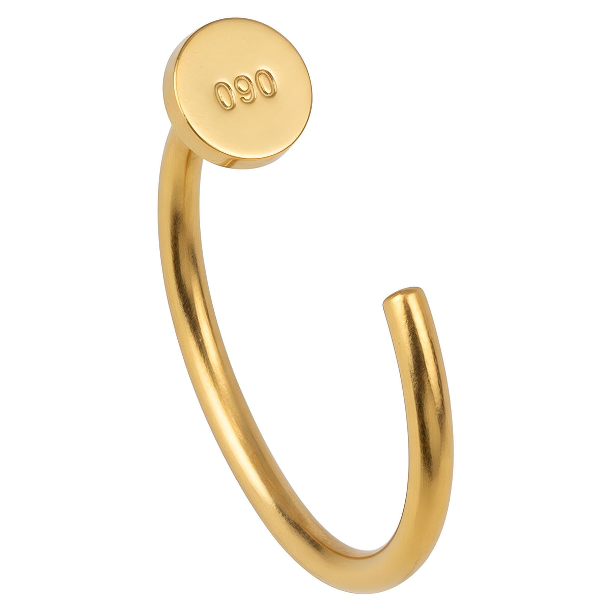 A gold-colored metal bracelet with a round, embossed button on the back.