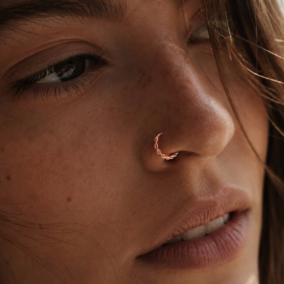 A close-up of a woman's face, focusing on her nose and eye.