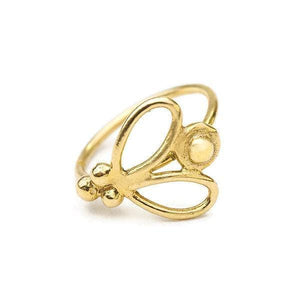 A gold-colored ring with a decorative design featuring a butterfly-like shape and three small balls.