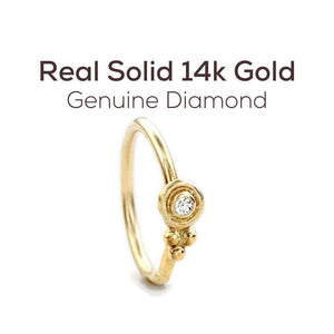 Diamond Nose Ring: a gold ring with a diamond set in the center.